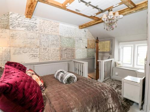 a bedroom with a large bed and a wall with maps at The Mouse House in Elton