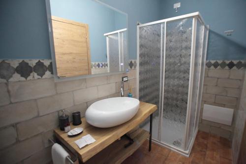 a bathroom with a white sink and a shower at La CASA DEGLI ARTISTI in Tuscania