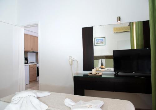 a room with a bed and a large mirror at Villa Lilly in Tolo