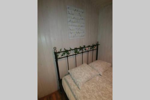 a small bed in a room with at Cosy Cottage-Álfabakki-with hot tub in Stóri-Bakki