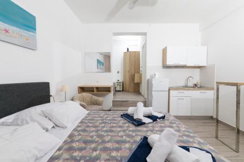 a bedroom with a bed with towels on it at Stella Mare Eco Boutique House in Zavala