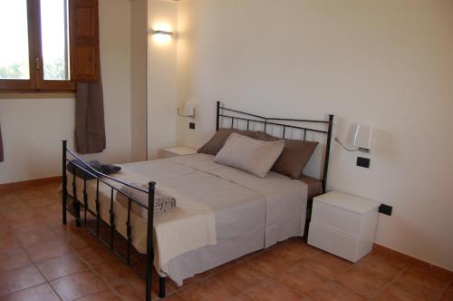 a bedroom with a bed with a metal frame at Masseria La Duchessa in Veglie