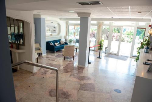 a living room with a blue couch and a table at Hotel Faro de San Vicente in San Vicente de la Barquera