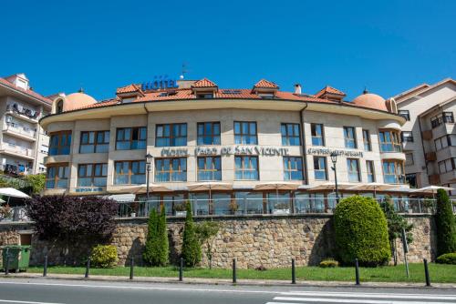 a building on the side of a stone wall at Hotel Faro de San Vicente in San Vicente de la Barquera