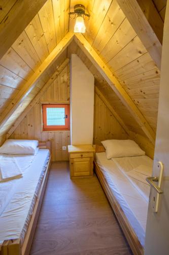 a room with two beds in a attic at Vila Tijana in Žabljak