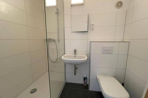 a small bathroom with a toilet and a sink at Ferienwohnung an der Ostsee in Rostock