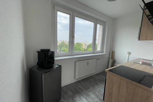 a room with a refrigerator and a window at Ferienwohnung an der Ostsee in Rostock