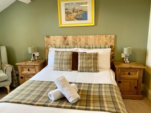 
a bedroom with a bed and a dresser at Number 19 Guest House in Barrow in Furness
