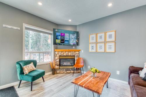 a living room with a couch and a fireplace at Beautiful Newly Reno 2BDM 2 Bth Sleep up to 6 Adults & Kids Mountain View Townhouse Suite in Canmore