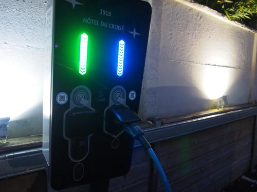 a parking meter with a hose attached to it at Hotel Du Croisé in Marcq-en-Baroeul