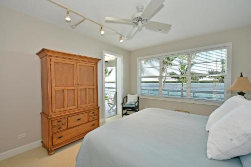 a bedroom with a bed and a dresser and a window at Harbor Villa Club 206 in Longboat Key