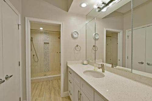 a white bathroom with a sink and a shower at Harbor Villa Club 206 in Longboat Key