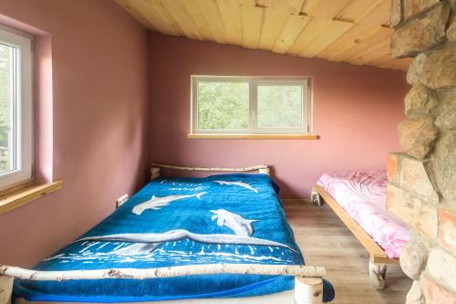 a bedroom with a bed in a small room at Super Sodyba in Pamusiai
