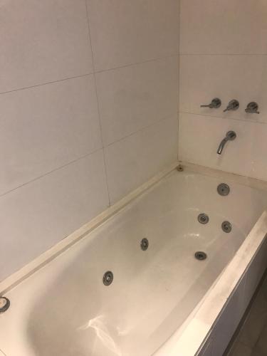 a white bath tub in a bathroom with a shower at Incomparable Vista al Golf in Mar del Plata