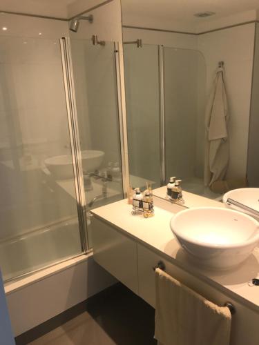 a bathroom with a white sink and a shower at Incomparable Vista al Golf in Mar del Plata