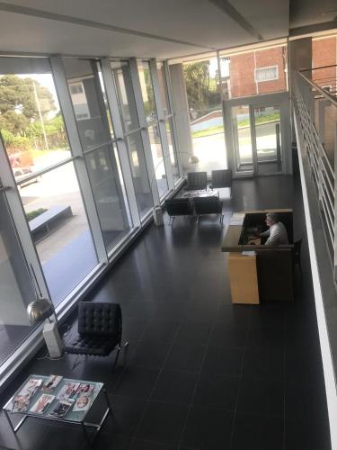 a man sitting at a desk in an office at Incomparable Vista al Golf in Mar del Plata