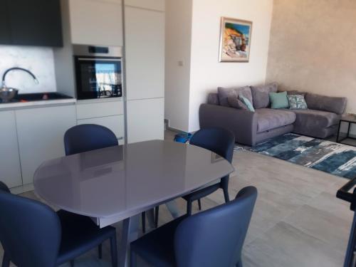 a kitchen and a living room with a table and chairs at Martin Lux Apartment in Krasici