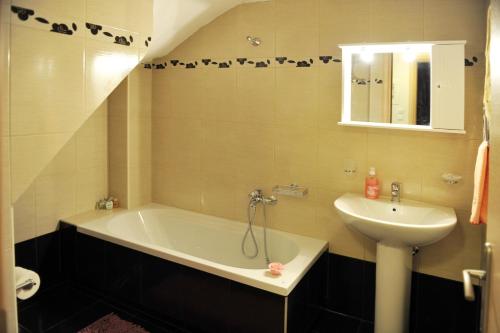 a bathroom with a bath tub and a sink at Lemon Tree in Nydri