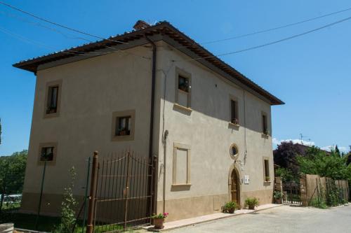 a small house with a fence in front of it at Antica Casa del Glicine in Poggibonsi