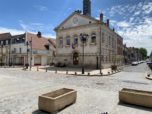 an old building with a clock tower on a street at Champagne & Grand Cru in Ay