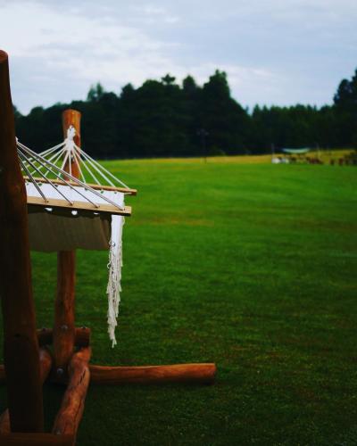 a icicle hanging off the side of a wooden structure in a field at Monasteria in Stare Monasterzysko