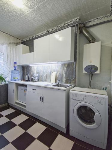 a kitchen with a washing machine and a sink at Смарт квартира на победе in Dnipro