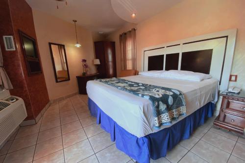Ένα ή περισσότερα κρεβάτια σε δωμάτιο στο Hotel Hacienda del Viejo