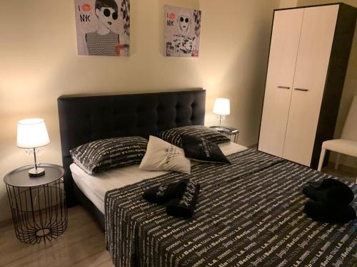 a bedroom with a bed with two black shoes on it at hortenzia in Alba Iulia