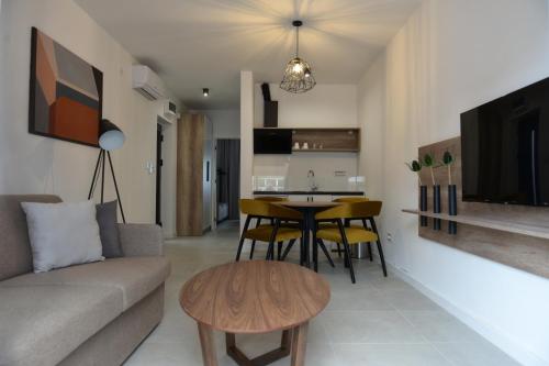 a living room with a couch and a table at 9 apartments in Jagodina