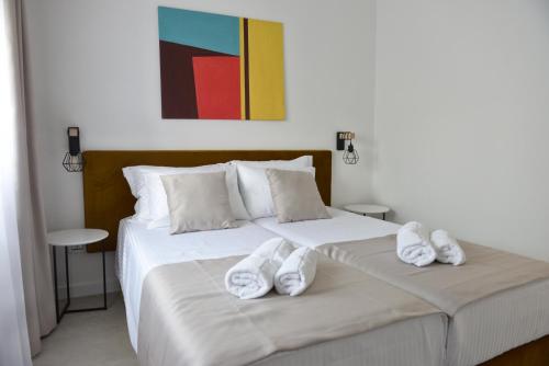 a bedroom with two beds with white towels on them at 9 apartments in Jagodina