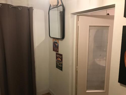 łazienka z lustrem obok drzwi w obiekcie Appartement entre Océan et montagne 15bis avenue de Montbrun Anglet w mieście Anglet