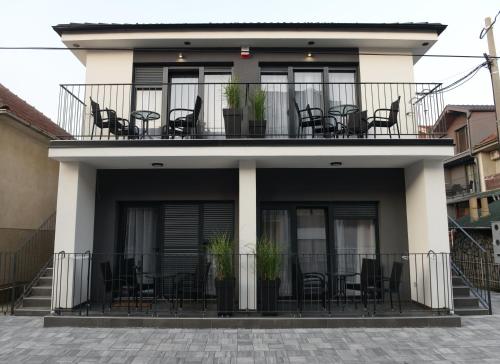 a building with chairs and tables on a balcony at 9 apartments in Jagodina