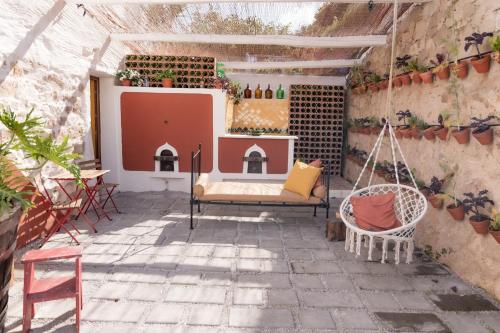 an outdoor patio with a swing and a fireplace at Obidos Rural Chic House in Usseira