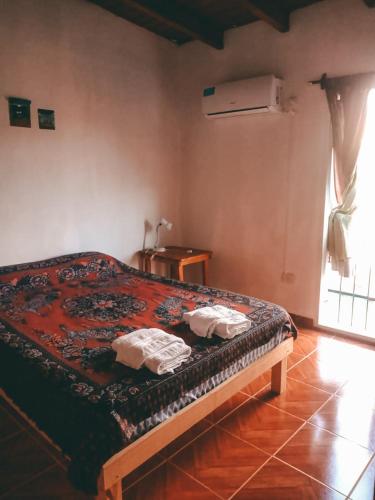 a bedroom with a bed with two towels on it at Altos Valles del Sol in Cafayate