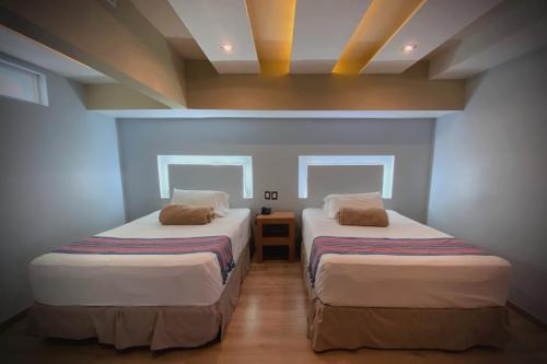 Ένα ή περισσότερα κρεβάτια σε δωμάτιο στο Hotel Hacienda del Viejo