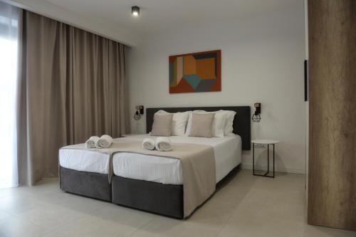 a bedroom with a large bed with towels on it at 9 apartments in Jagodina