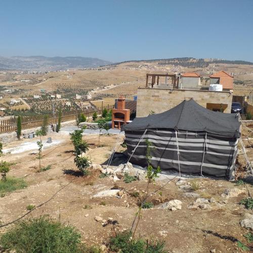 a black and white tent sitting on top of a field at Dar Gerasa chalets - شاليهات دار جراسا in Jerash