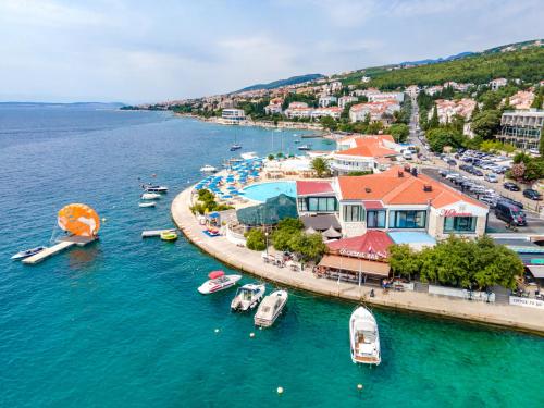an aerial view of a harbor with boats in the water at Hotel Millenium deluxe in Selce