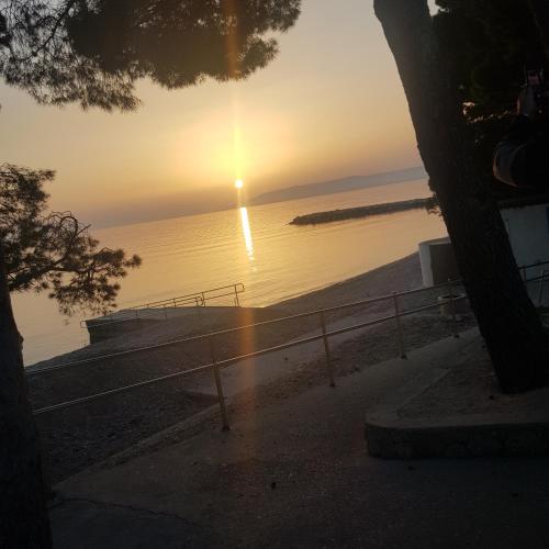 a view of the ocean at sunset at Lorena Luxury Apartment in Makarska