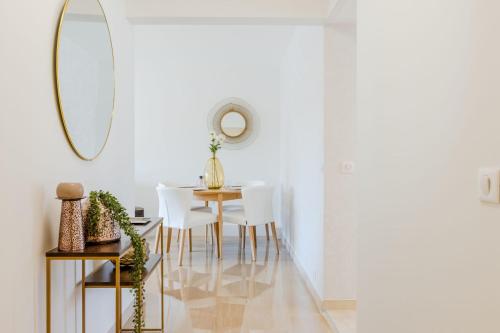 une salle à manger avec une table et un miroir dans l'établissement Stylish 1-Bedroom Apartment Close to Beaches, à Cannes