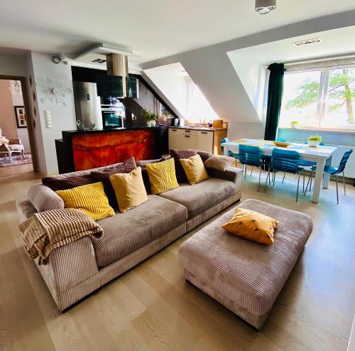 una sala de estar con un sofá y una mesa en Lake View Ostróda Luxury Apartment, en Ostróda