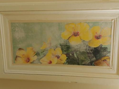 a picture of yellow flowers in a painting at San Domenico Casa Vacanze in Modica