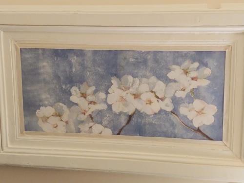 a painting of white flowers on a blue background at San Domenico Casa Vacanze in Modica