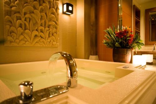 a bathroom sink with a faucet and a mirror at HOTEL KSEA (Adult Only) in Matsudo