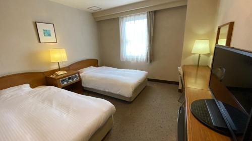 Кровать или кровати в номере Smile Hotel Nabari