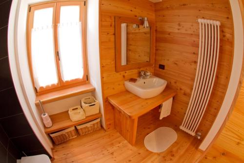 a small bathroom with a sink and a mirror at Tesino Appartamenti 2 in Castello Tesino