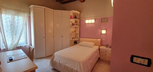 a small bedroom with a bed and a window at B&B SERENA in Perugia