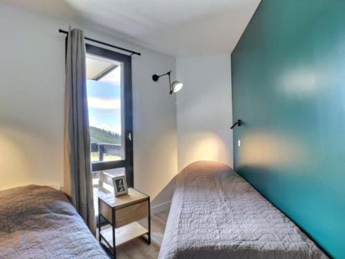 a bedroom with two beds and a window at Appartement Méribel, 2 pièces, 4 personnes - FR-1-182-240 in Les Allues