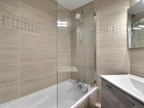 a bathroom with a shower and a tub and a sink at Appartement Méribel, 2 pièces, 4 personnes - FR-1-182-240 in Les Allues