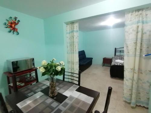 a living room with a table and a bedroom at DEPARTAMENTO CERCANO AL AEROPUERTO T2, A 2 CALLES in Mexico City